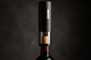 A sleek electric wine opener rechargeable device shown removing a cork from a bottle. Alt: Luxury electric wine opener rechargeable opening red wine bottle efficiently.