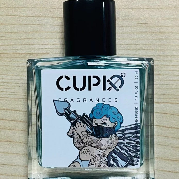 Perfume bottle with 'Cupid Fragrances' label on a wooden surface