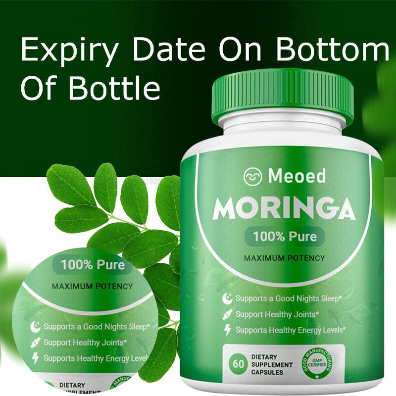 Moringa supplement bottle with green leaves on a green background